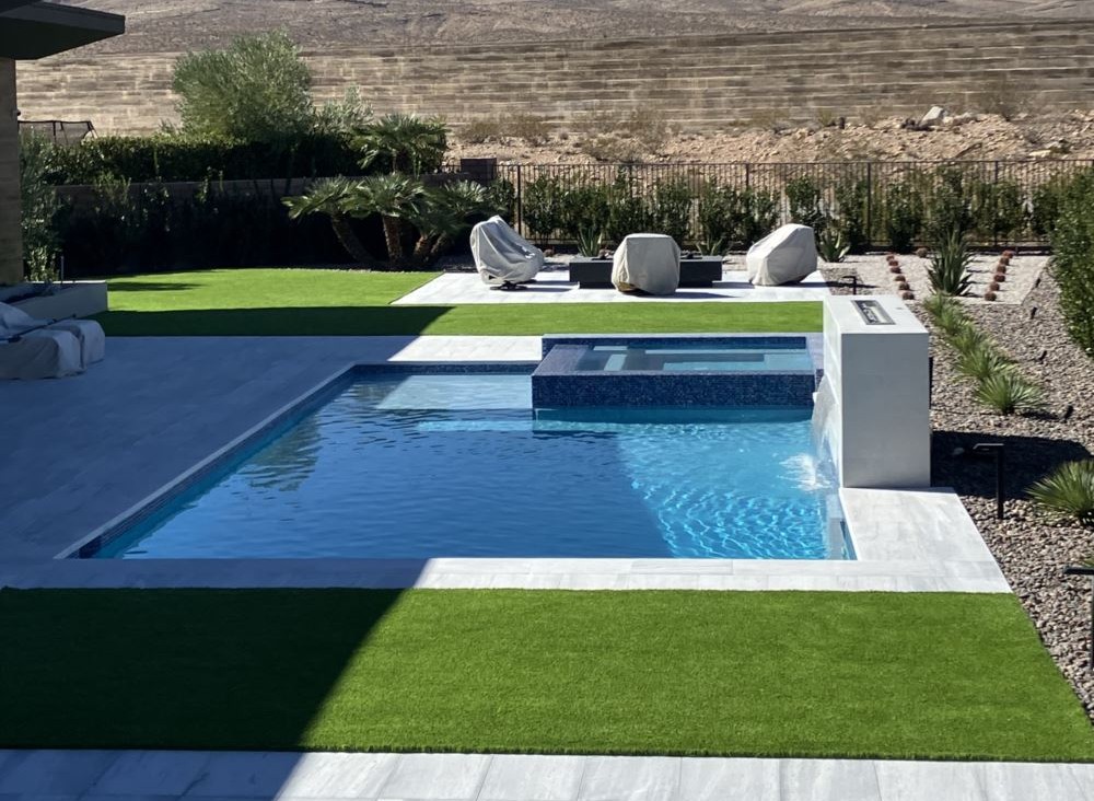 a swimming pool surrounded by artificial turf