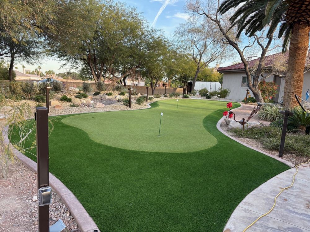 a putting green made from artificial grass in front of a house