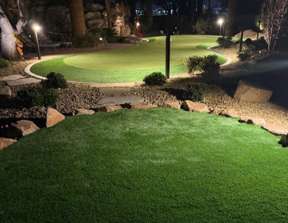 putting green with lights around it in the dark