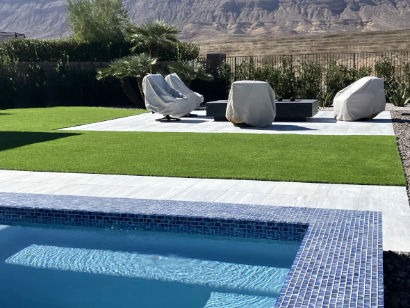 Backyard pool and artificial turf feature