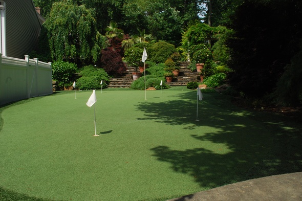 Las Vegas Synthetic grass golf green with flags in a landscaped backyard