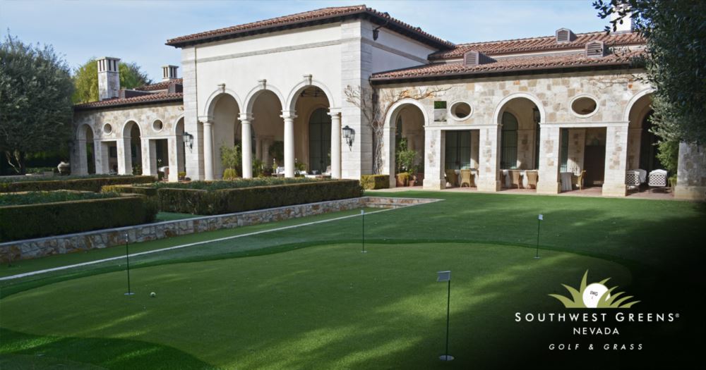 1:08 PM Luxury estate backyard with a multi-hole synthetic putting green installed by Southwest Greens of Nevada, surrounded by manicured hedges and a Mediterranean-style stone villa.